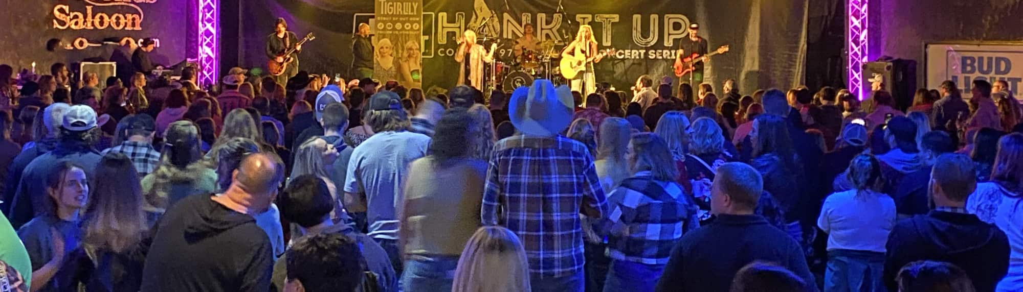 country concert with fans wearing cowboy hats New York City